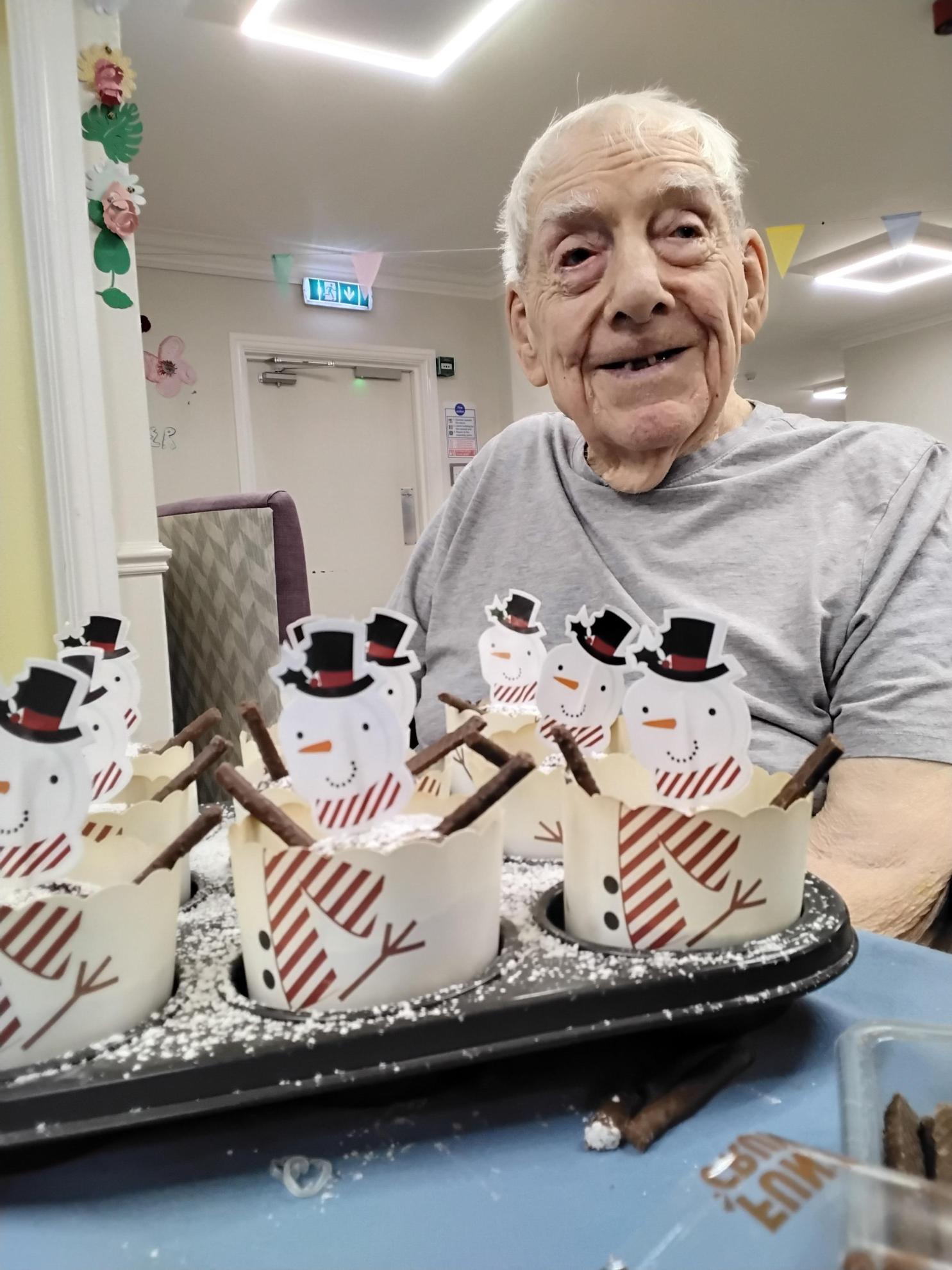 man holding some cupcakes