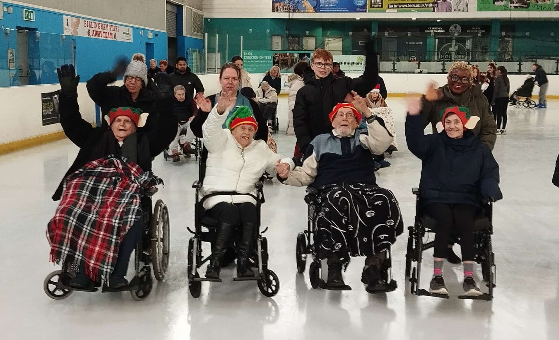 Residents and team members on the ice rink