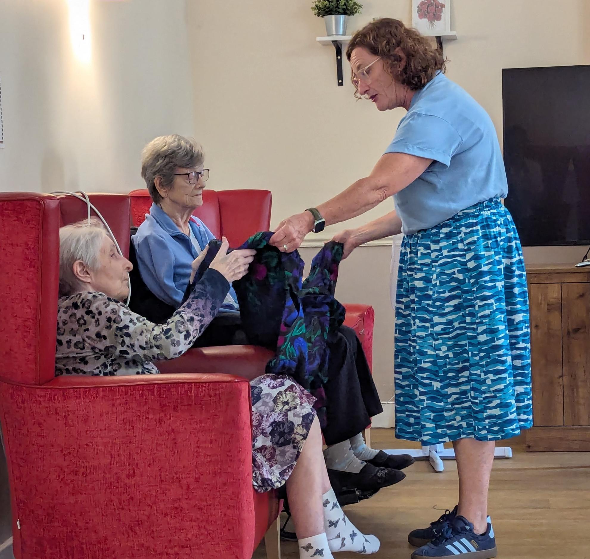 Bryony showing Joyce and Margaret colourful dress