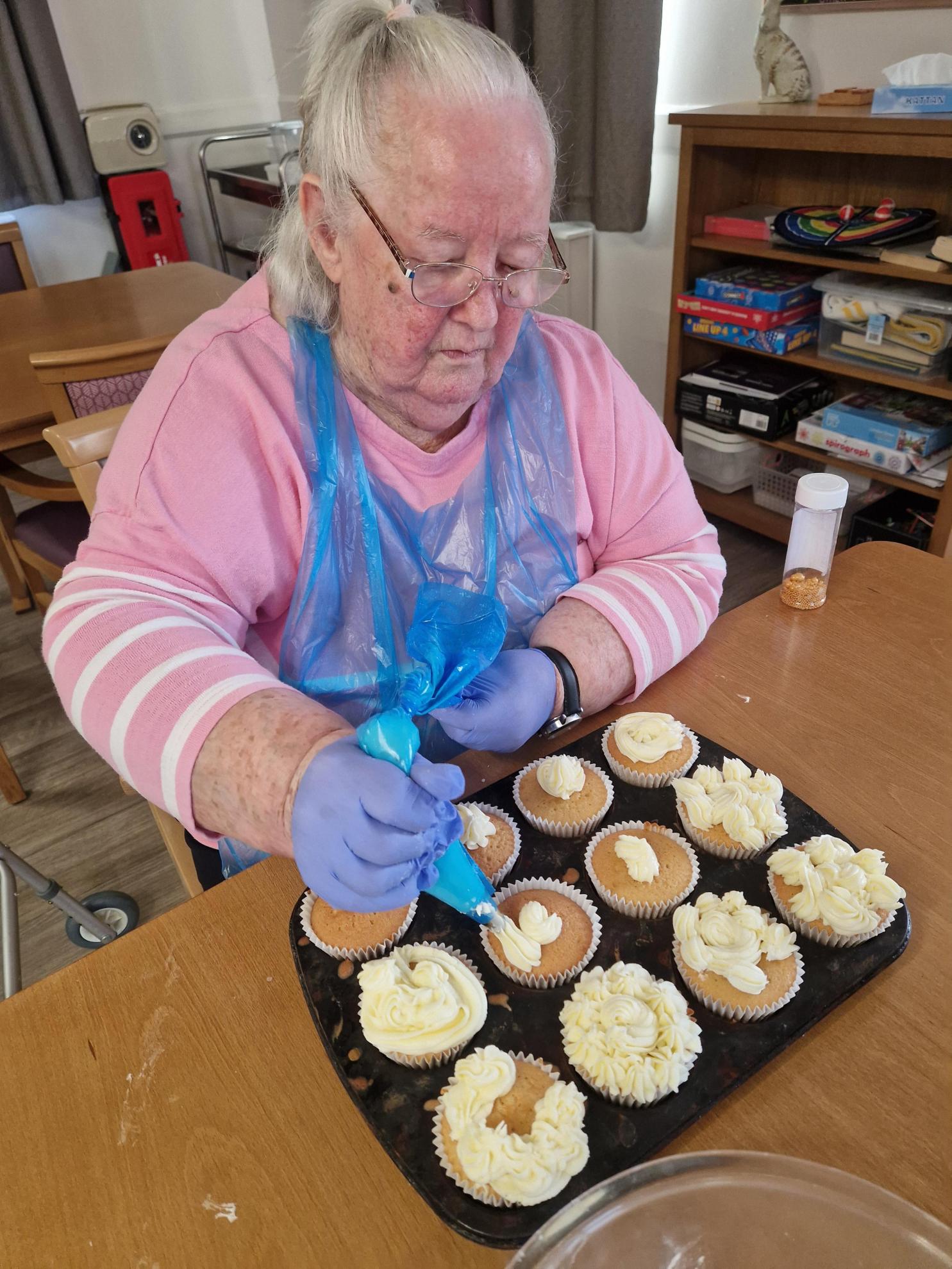 a lady decorating cupcakes