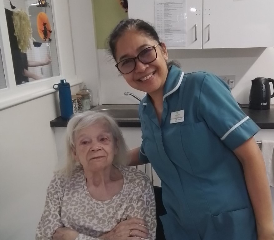 Alma and resident smiling together