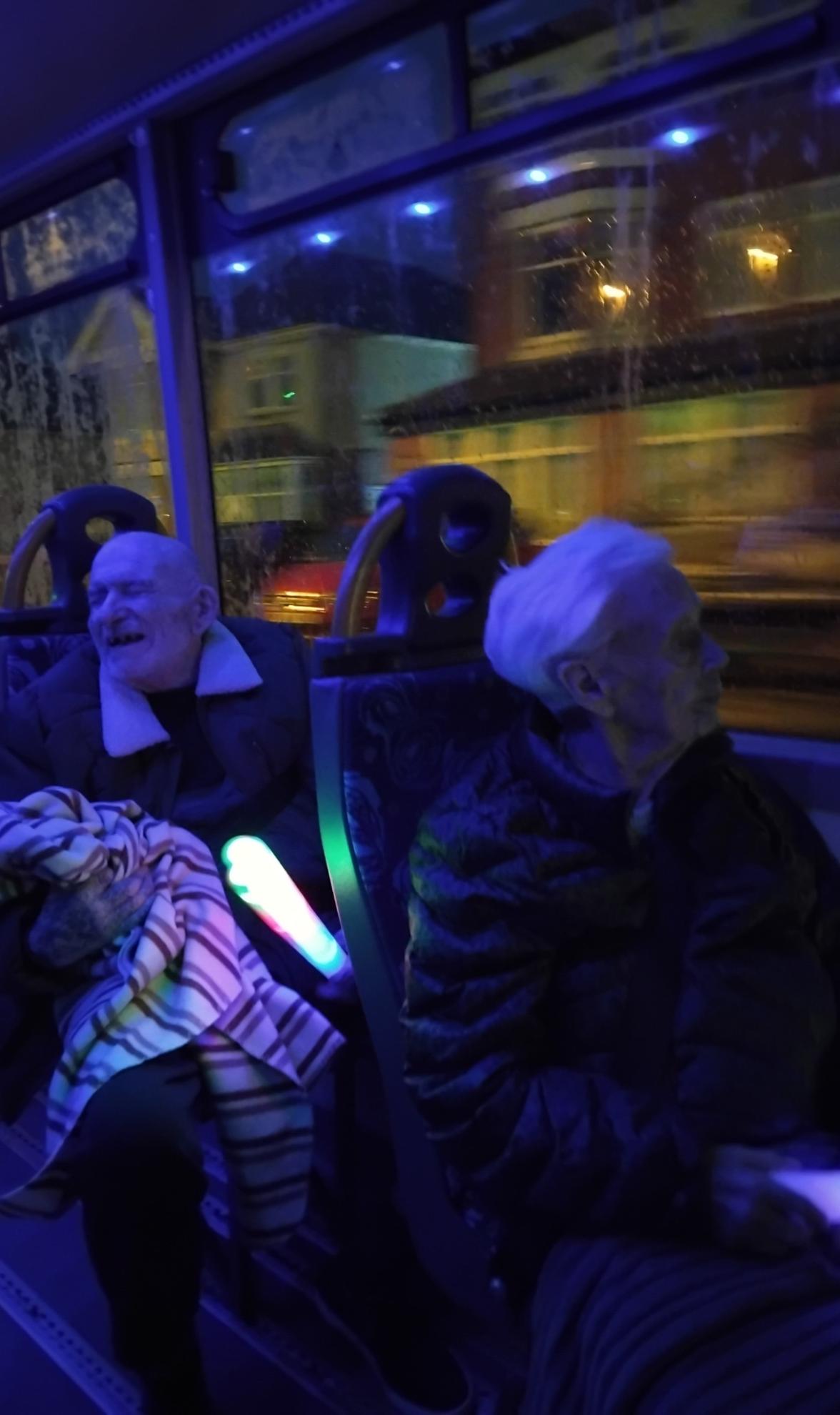 Photo of people on a bus enjoying the illuminations display