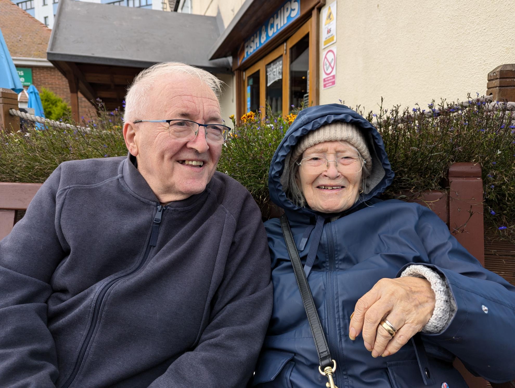 Happy people sat on bench