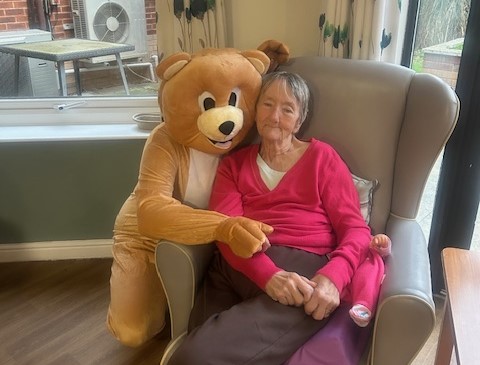 Castleford Bear with resident giving hugs