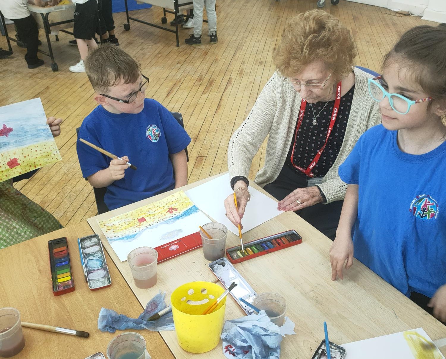 Sylvia drawing with two pupils