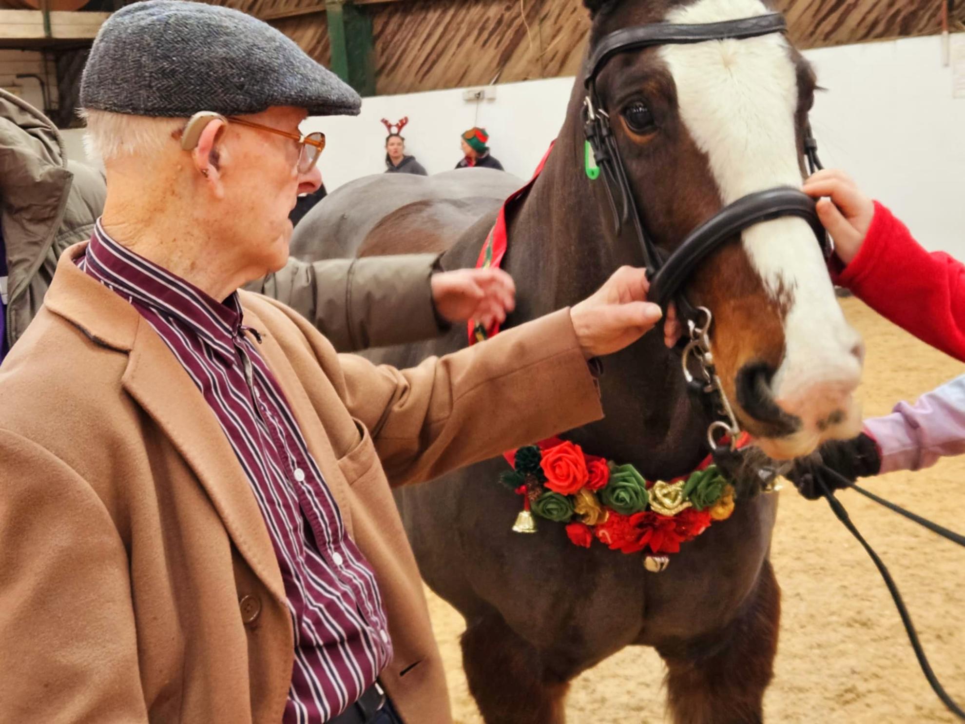 Photo of Peter stroking horse