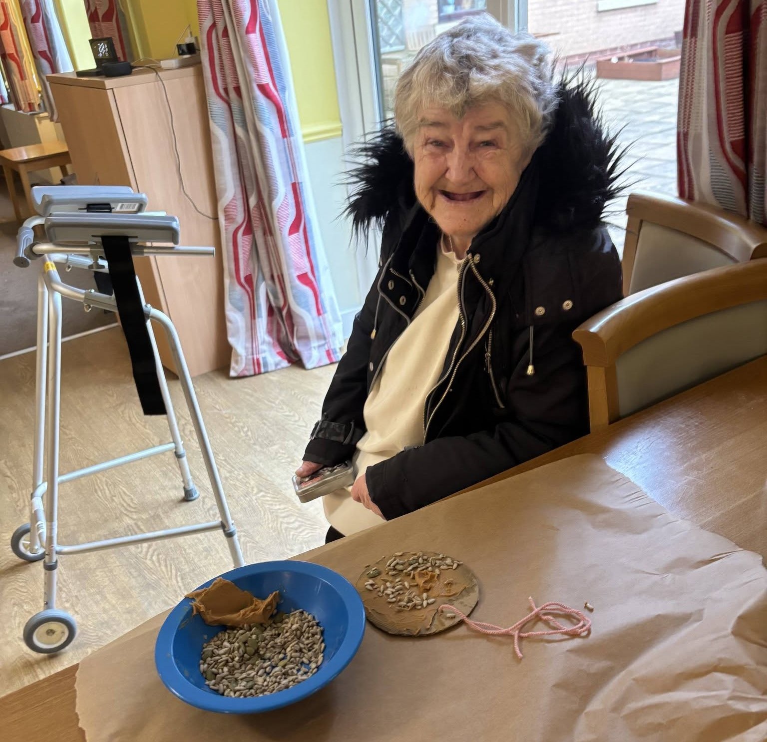 Picture of resident making bird feeder at Middleton