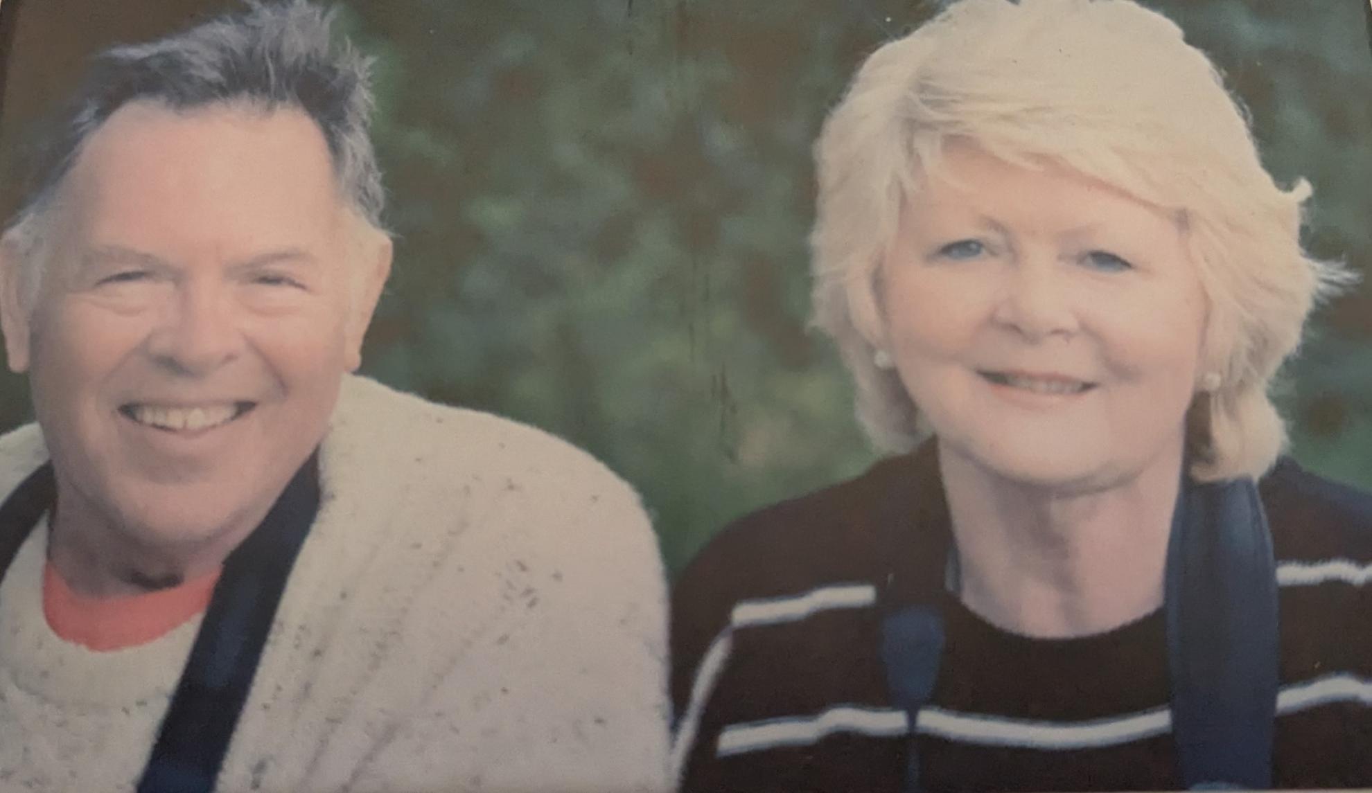 Old photo of Albert and Collette sat smiling together outside