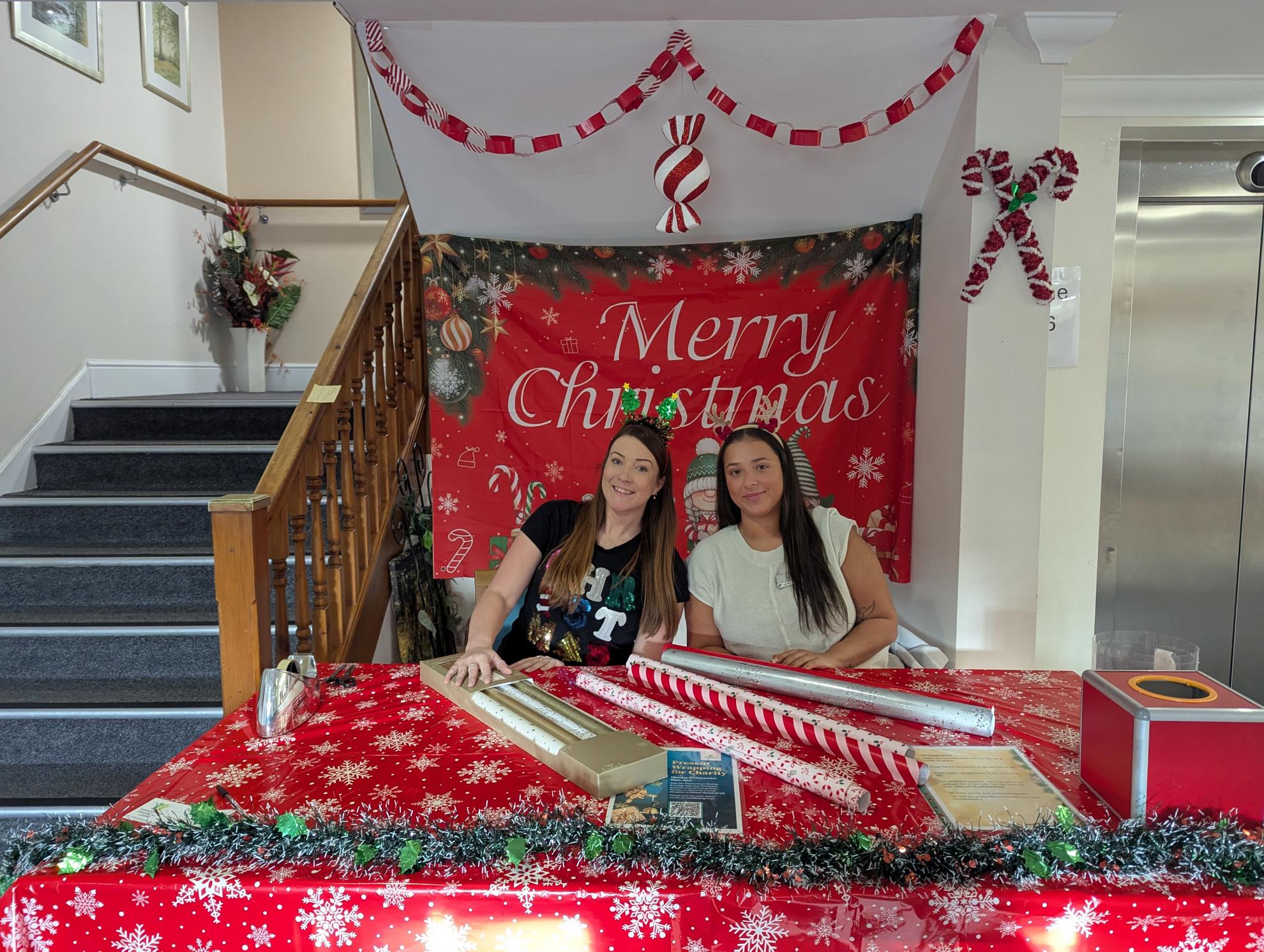 Photo of Jayne and Lucy at gift wrapping table