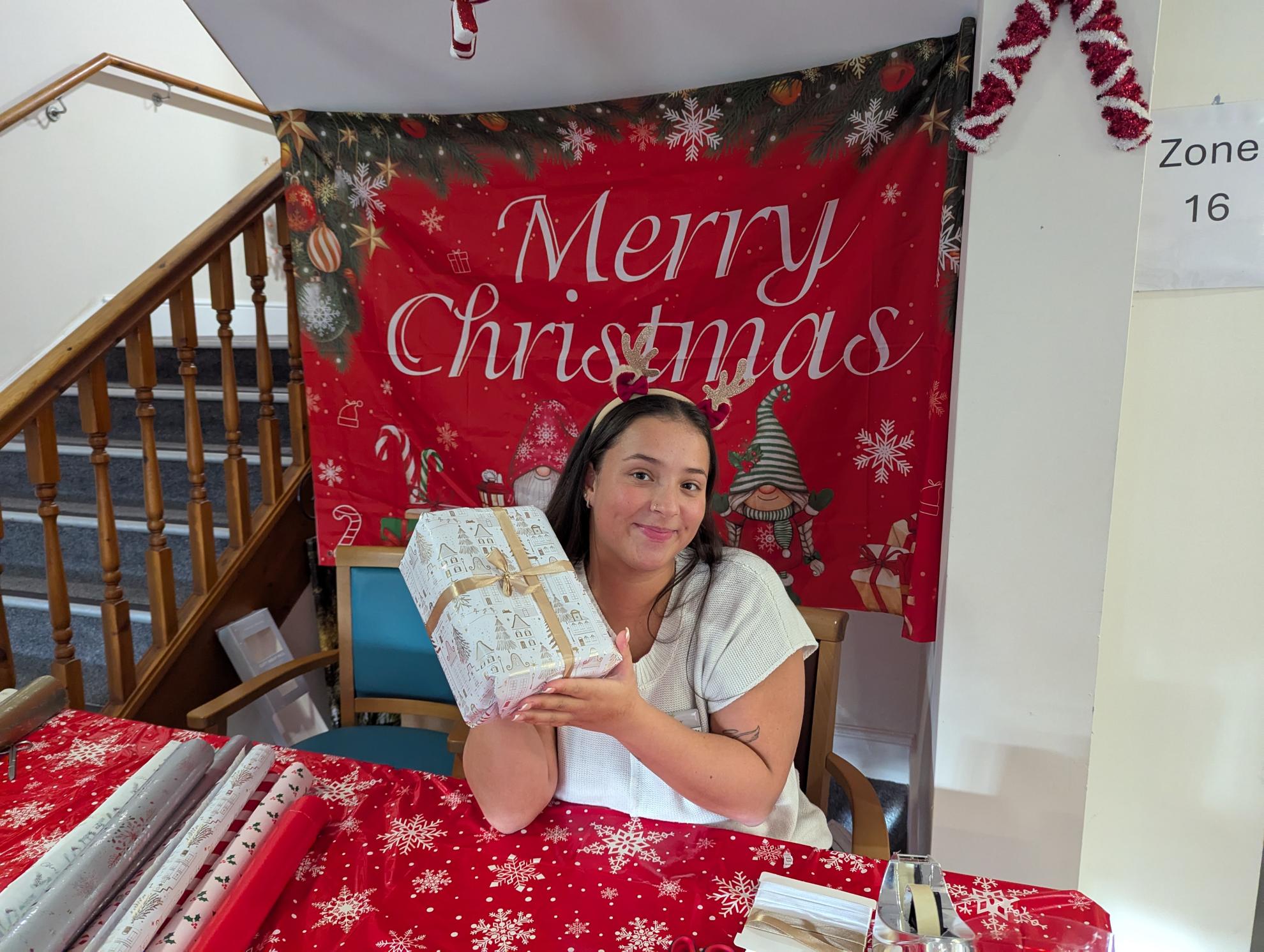 Photo of Lucy with wrapped gift