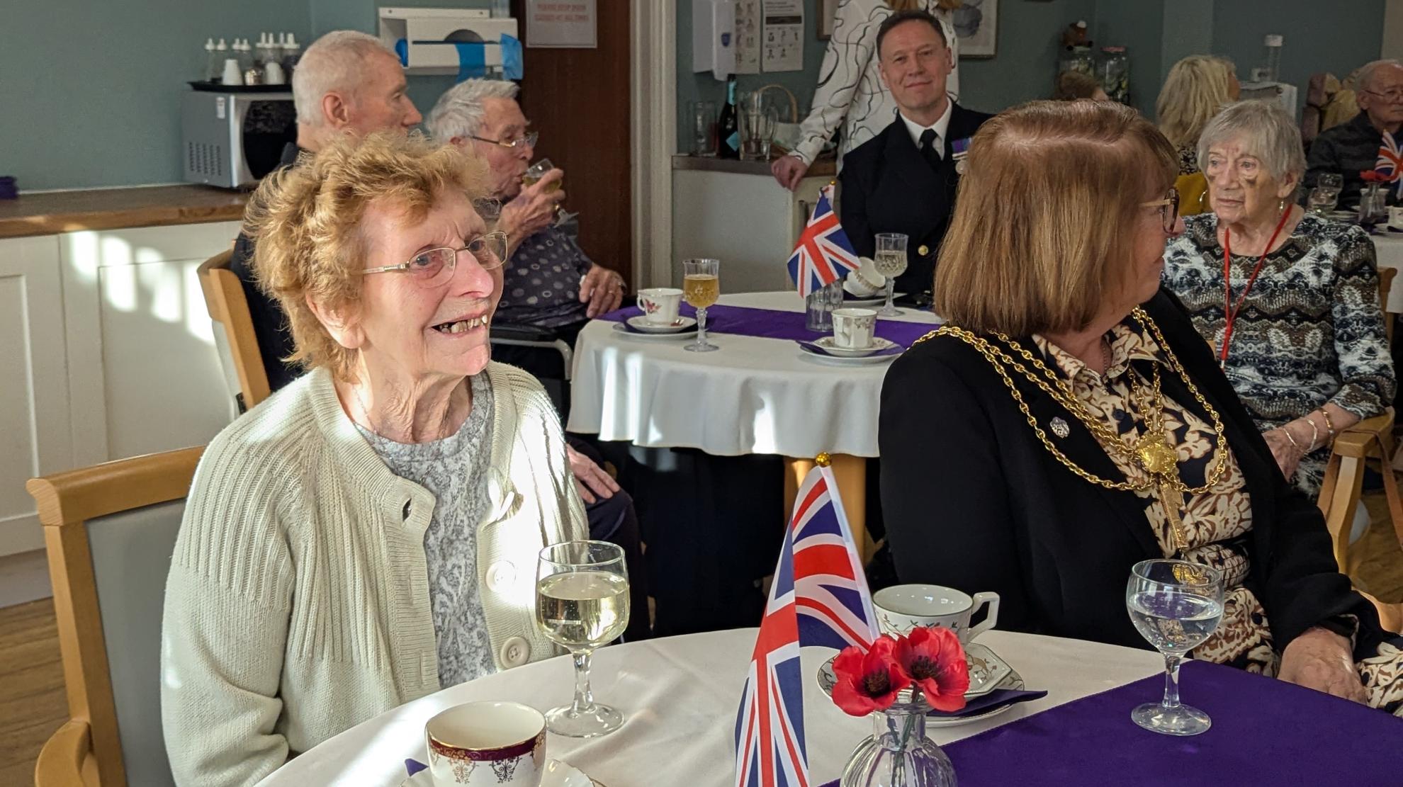 Photo of resident enjoying entertainment on Mayor's table