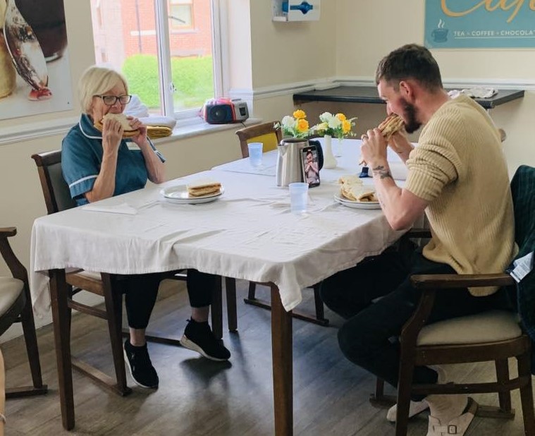 Chrissie and Ryan eating pizza for charity challenge