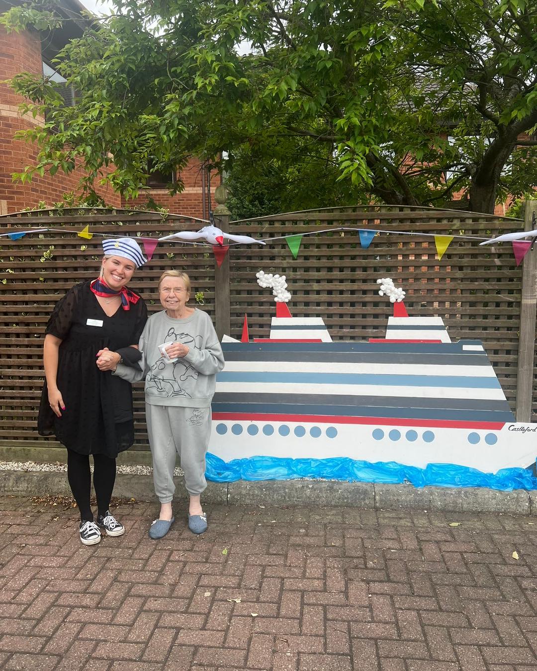 Photo of 2 people infront of ship
