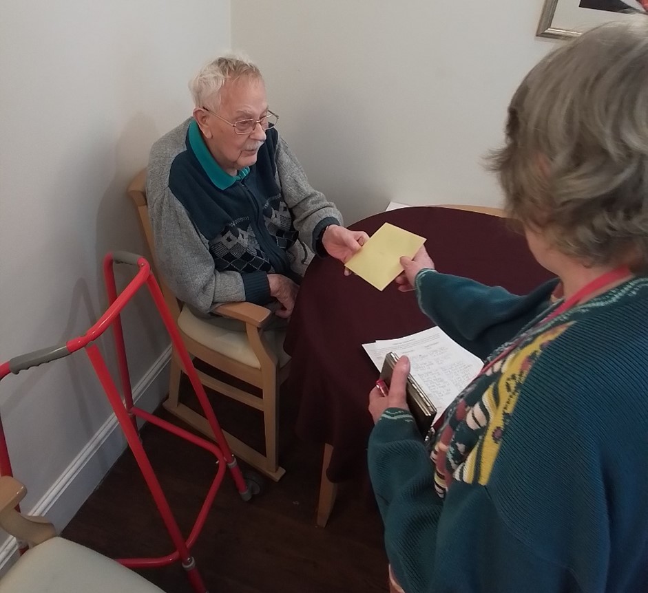 Jean giving her dad a Father's Day Card at Nesfield Lodge Dementia Care Home