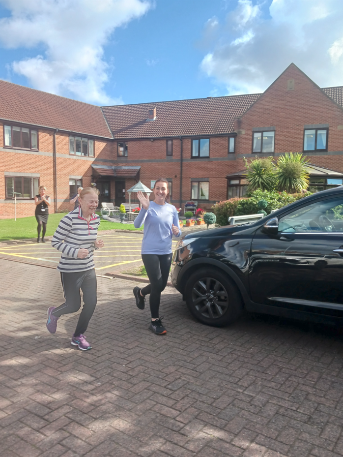 Caroline and Alex running outside Archers Court Care Home in Sunderland