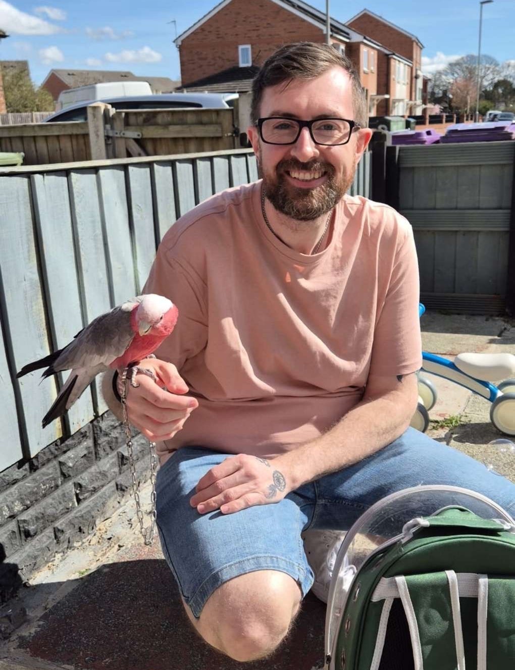 TJ smiling at camera holding a bird