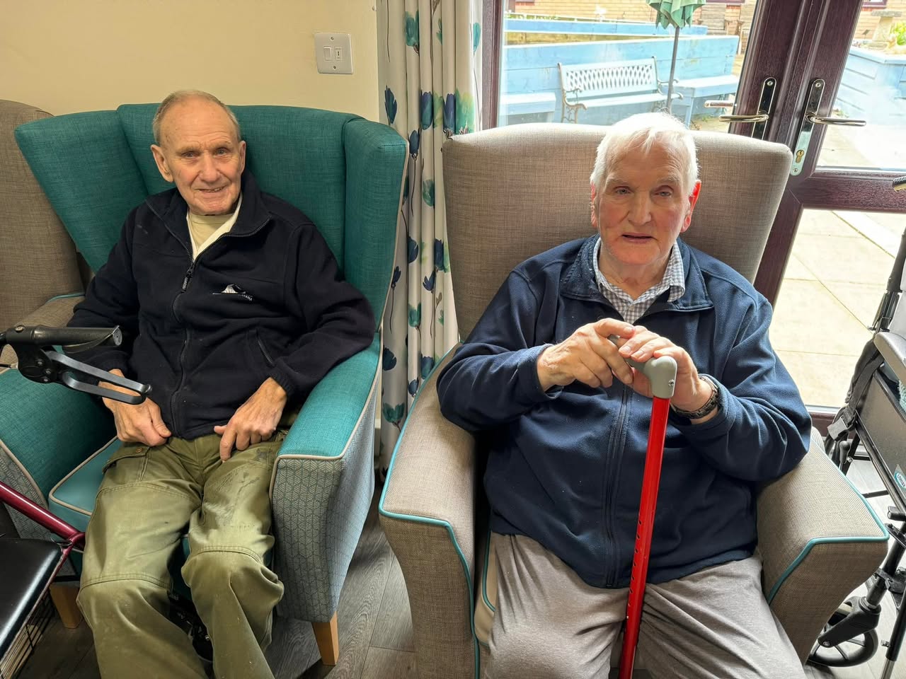 William and John seated and smiling together