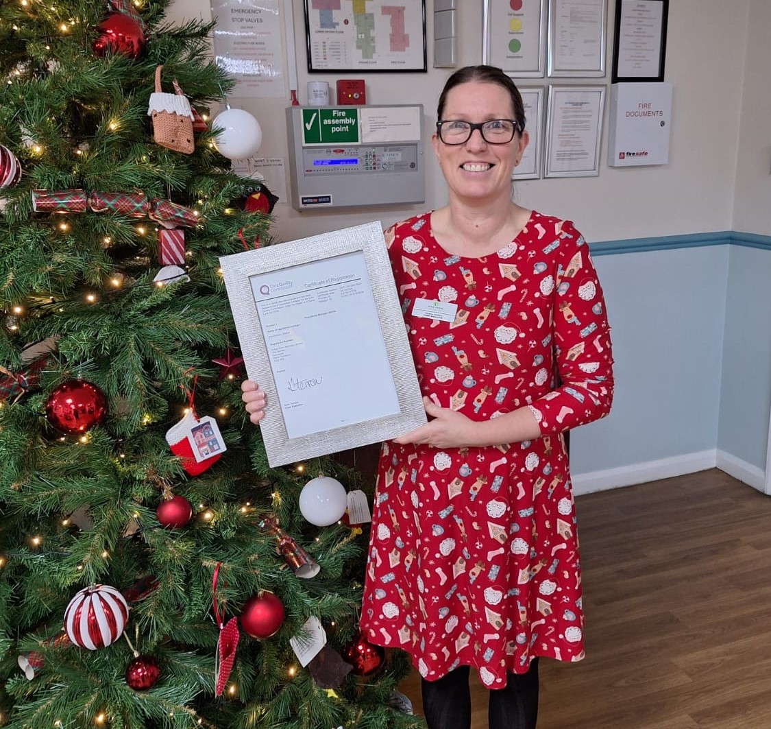 Photo of Zenka holding certificate