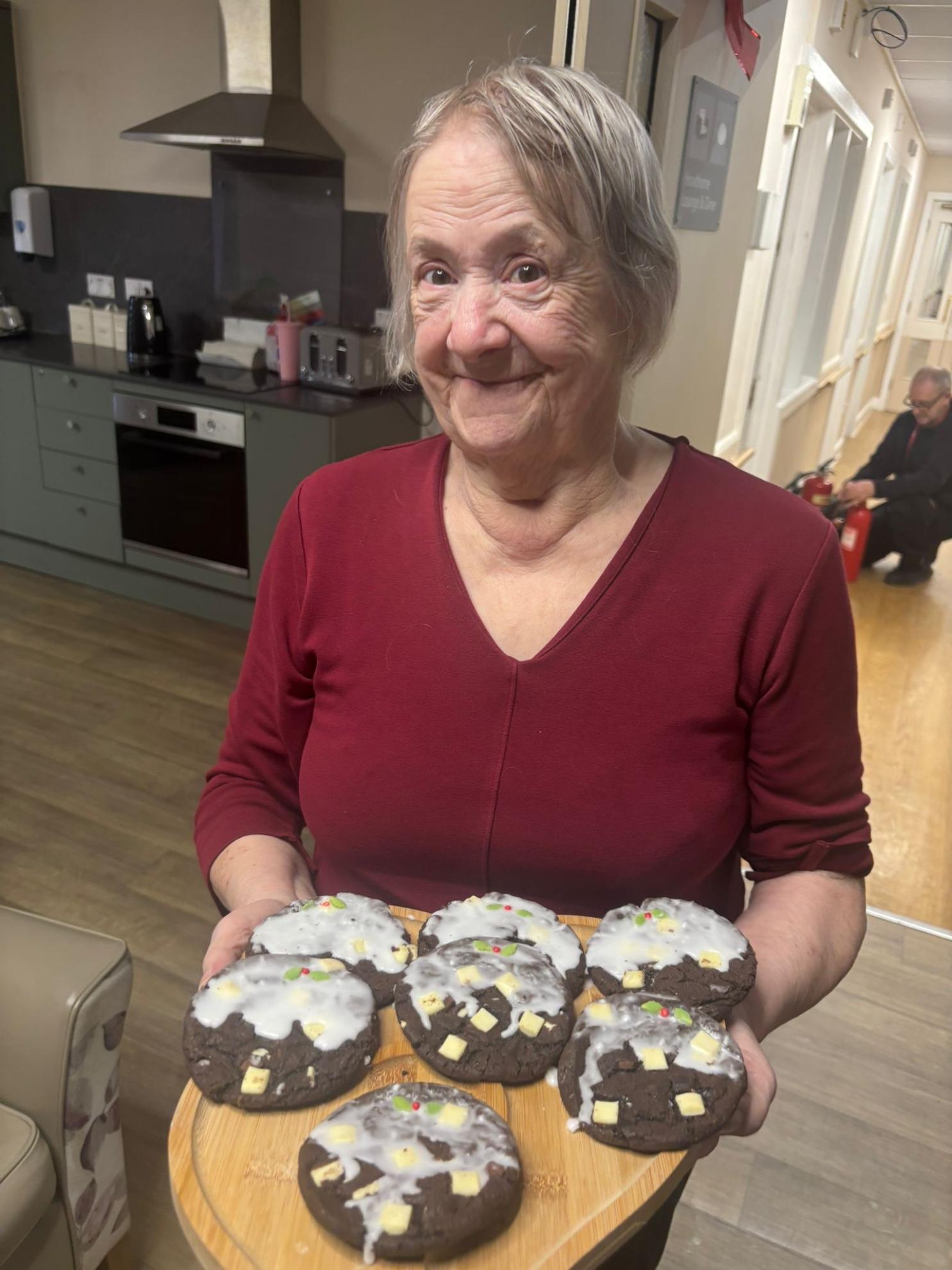 person holding some cookies on a tray