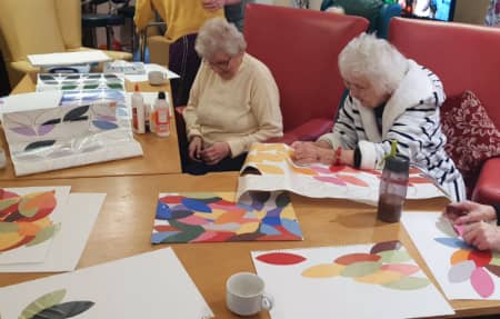 Residents using watercolours to paint some beautiful pictures.