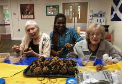 Residents and staff hard at work, making their bird feeder.