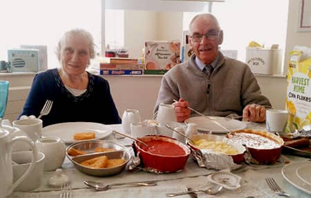 Two residents enjoying their breakfast.