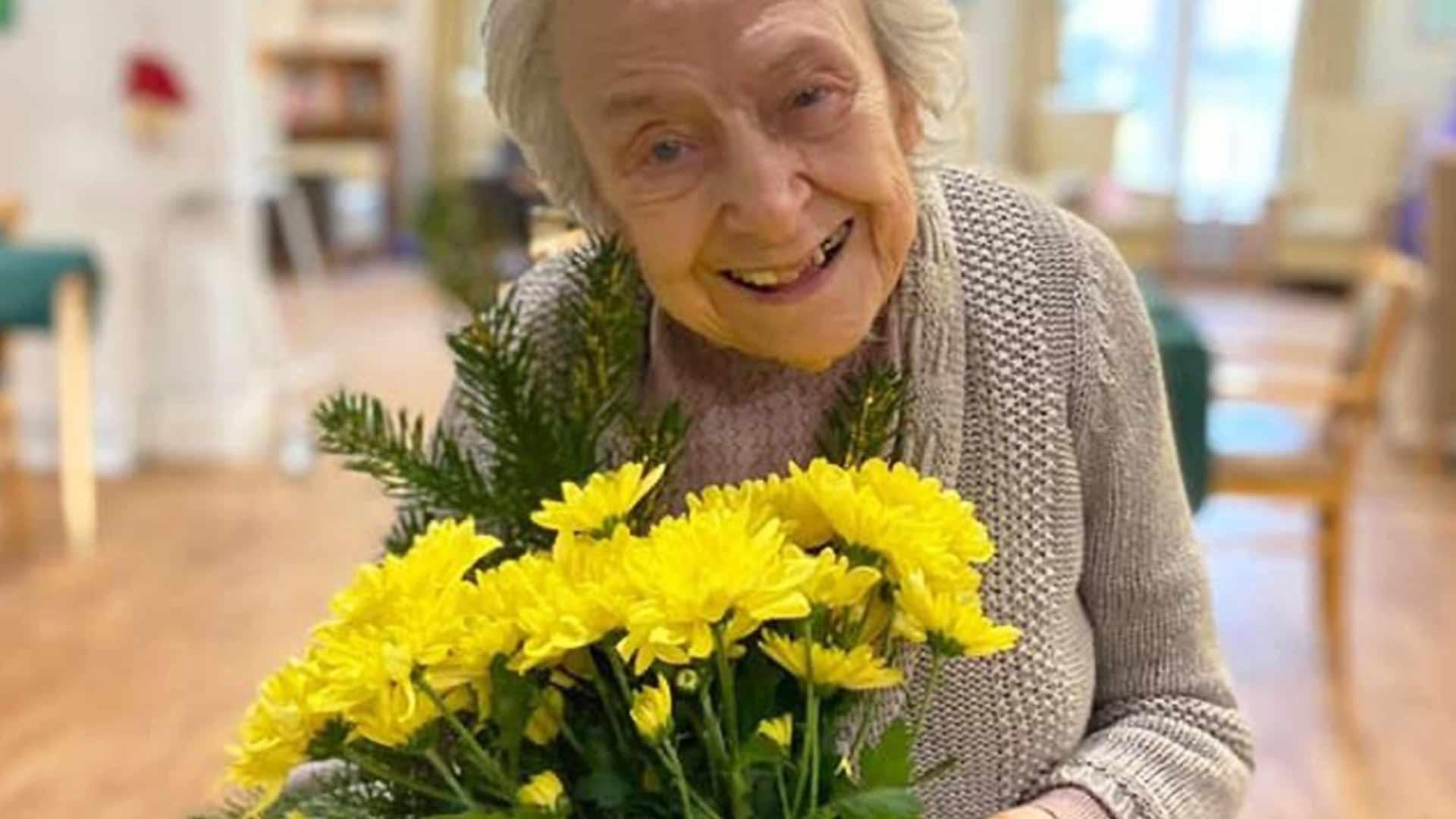 resident holding some flowers