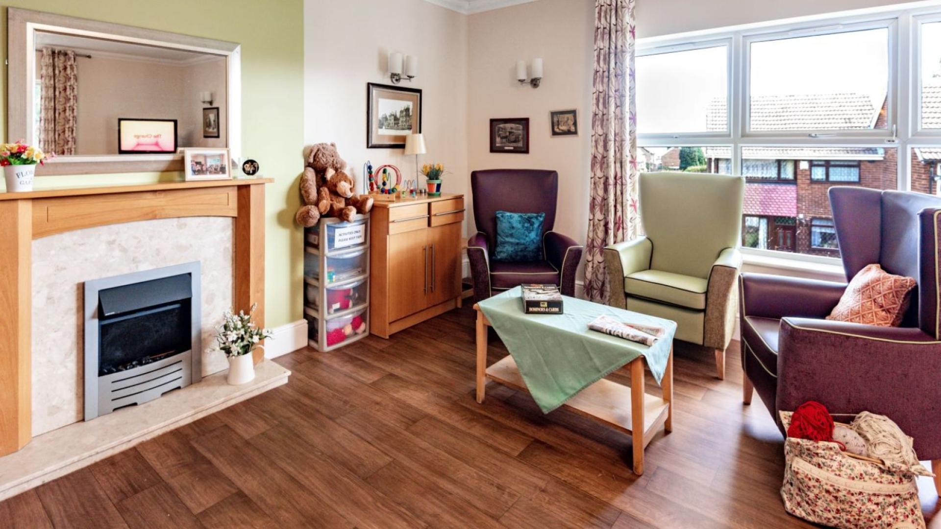 Living room with fireplace at Nesfield Lodge Dementia Care Home in Leeds