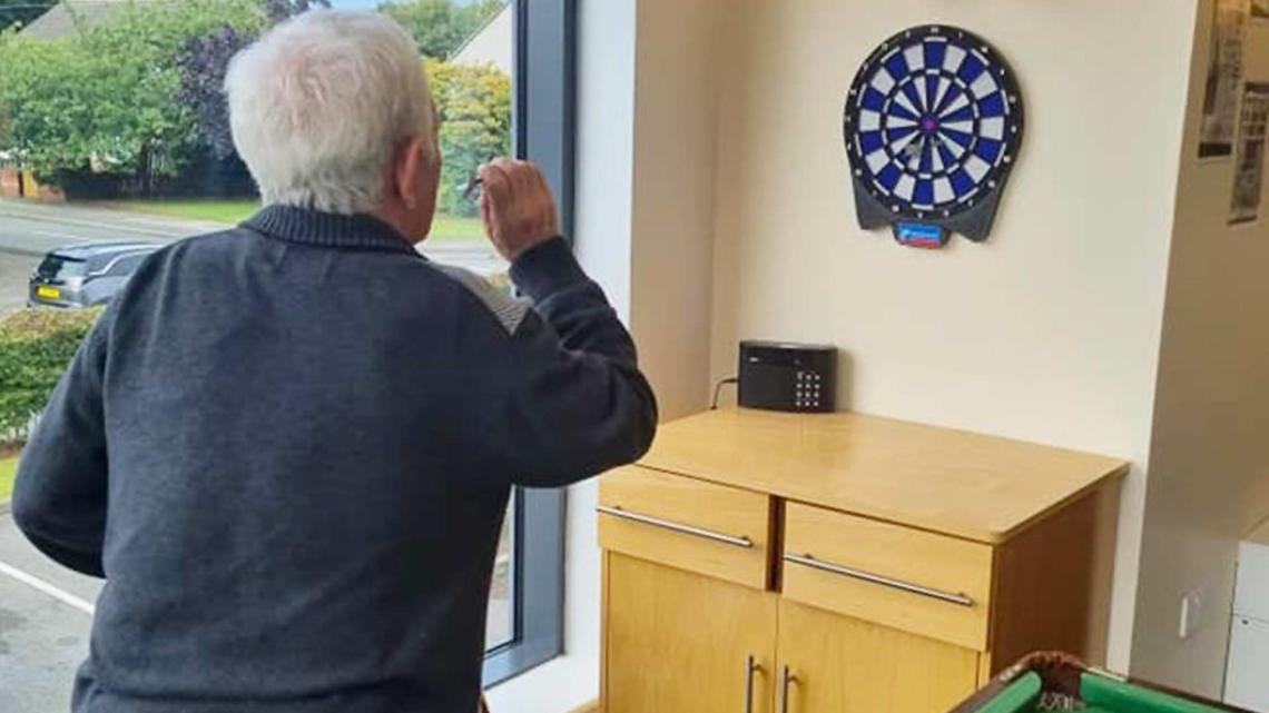resident playing darts
