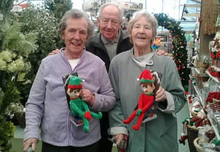 Three residents enjoying the Christmas decorations at Clays Garden Centre