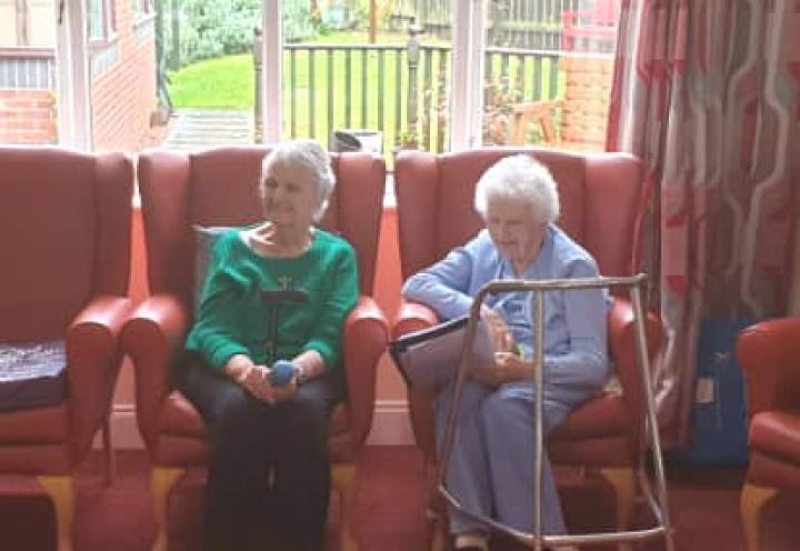 Residents singing from the song book