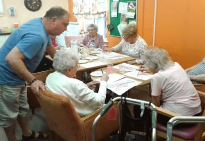 Chris helping the residents with their art work