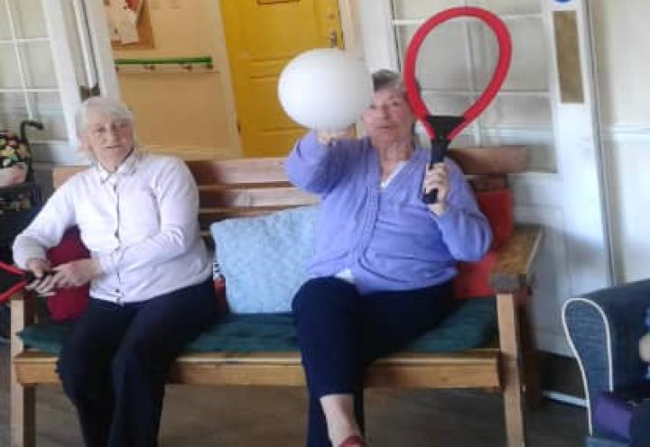 Residents hitting the balloon with their tennis racket