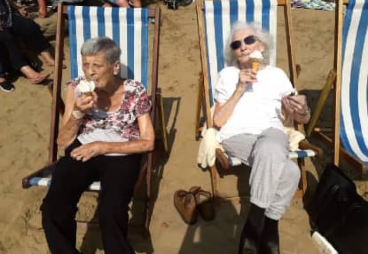 Residents relaxing on the beach with their ice cream