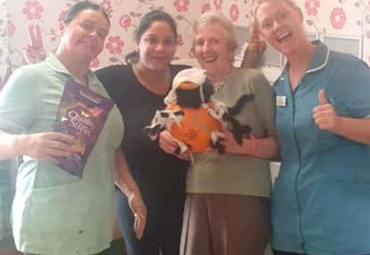 Staff and resident with the winning pumpkin and prize. 