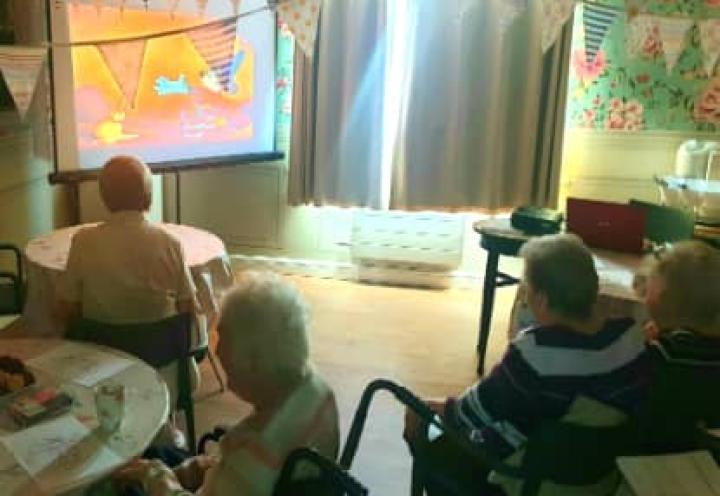 Residents watching Mickey Mouse. 