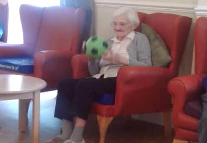 resident with a football in her hands. 