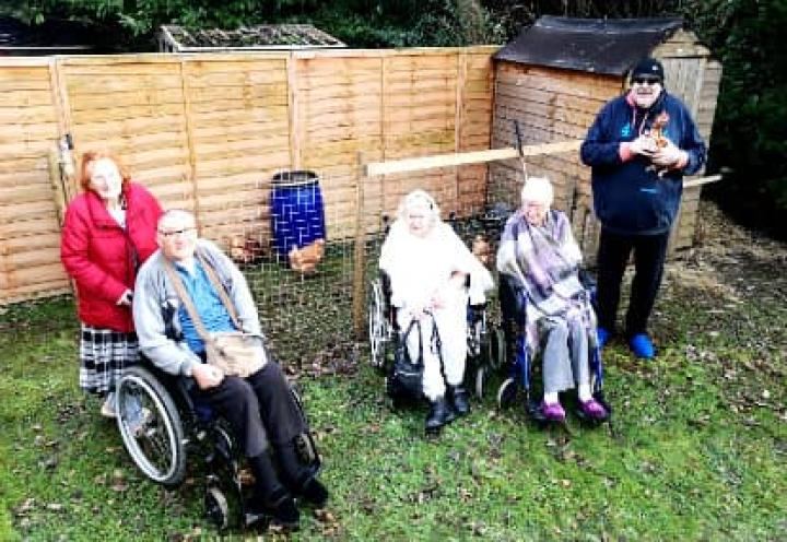 residents stood outside their new shed. 