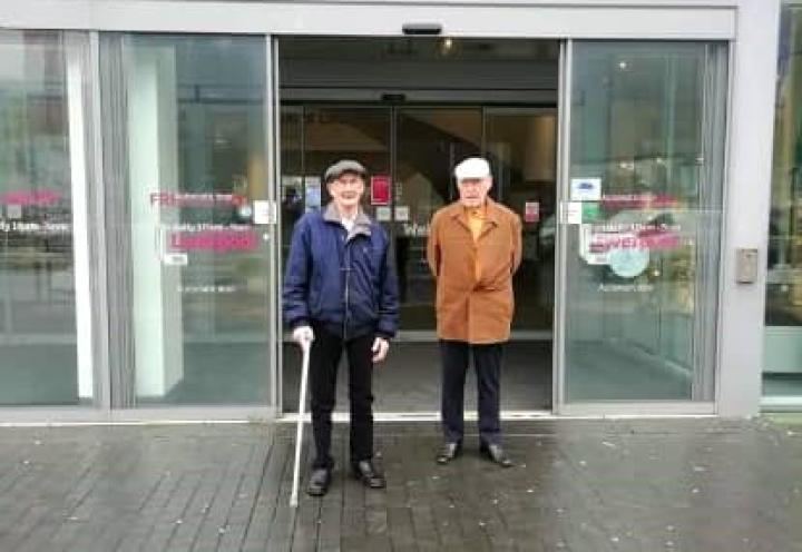 Gentlemen stood outside the museum. 