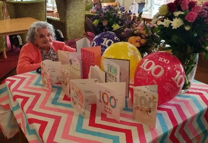 Vera surrounded by cards and flowers. 