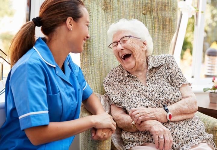 nurse and resident laughing together