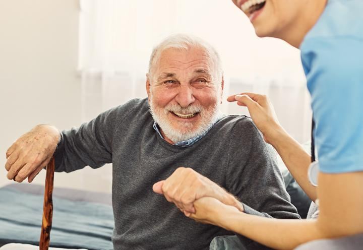 Man smiling with care worker