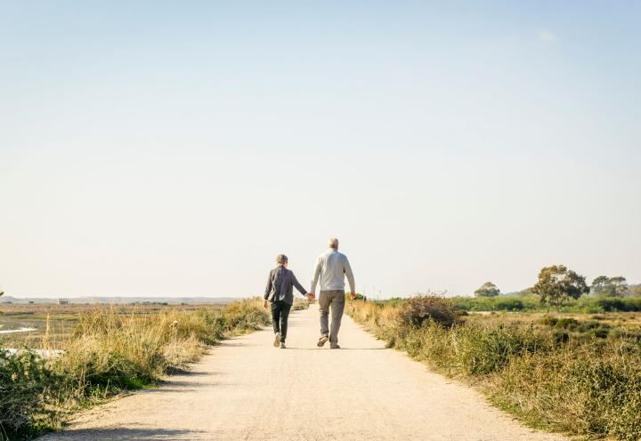 Picture of elderly couple walking near the beach