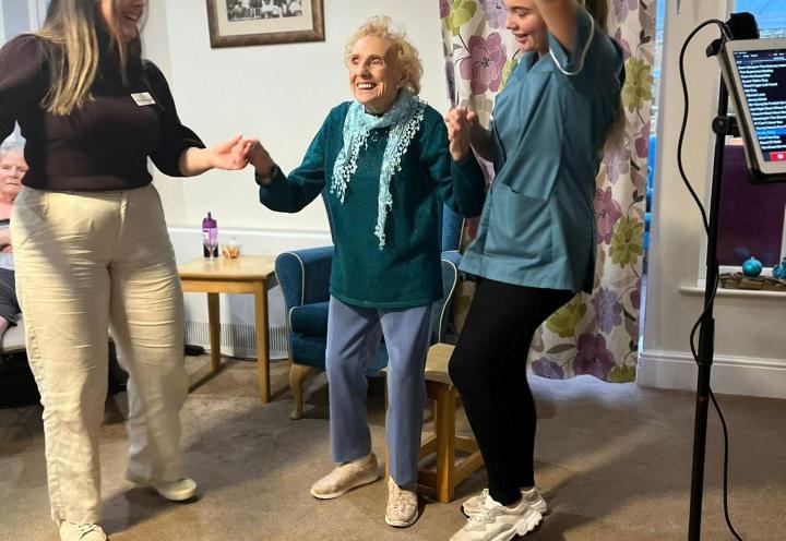 Photo of 3 women dancing and having a great time at a christmas party