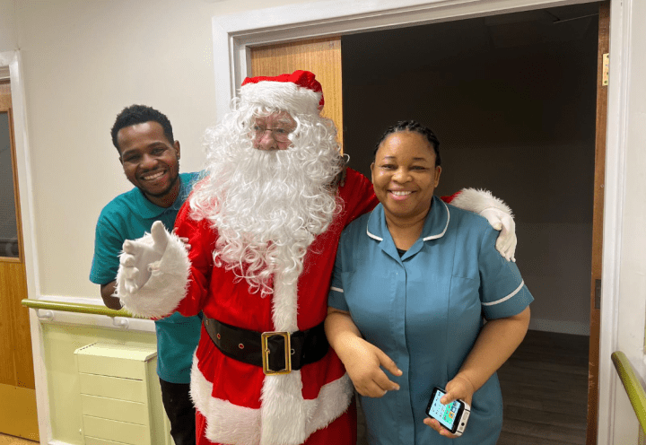 Photo of santa claus with 2 care home workers 