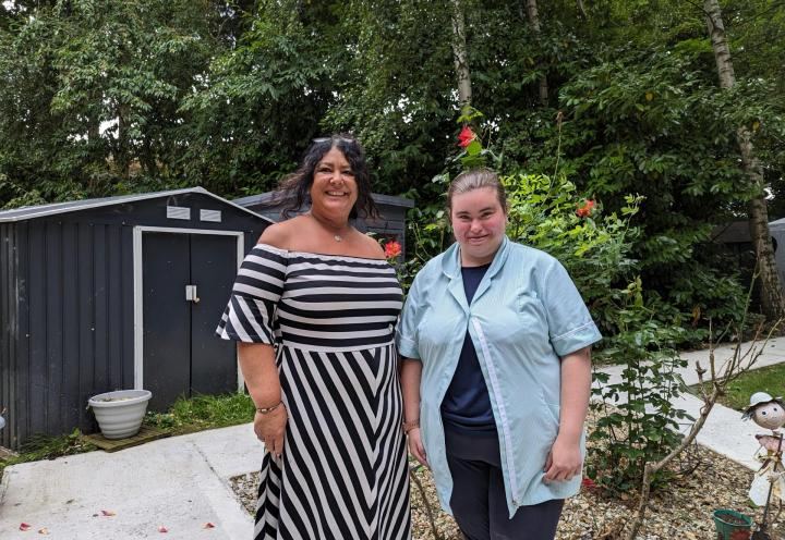 photo of 2 women in a garden smiling 