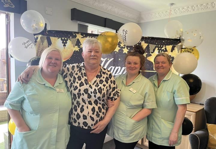 Group photo of Heather and her colleagues at the retirement party