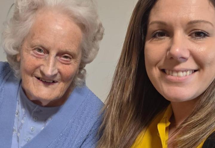 Roxie smiling next to a resident