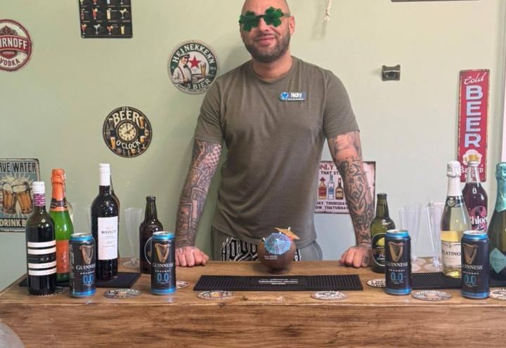 Man standing in front of bar