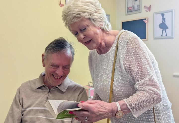 Albert and Collette reading bird-watching book together
